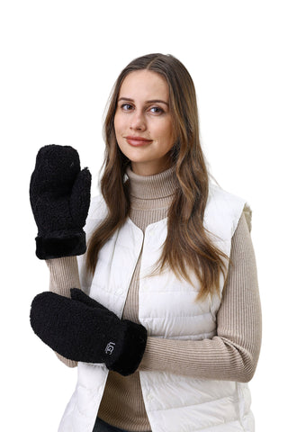 Woman holding black gloves against a white background