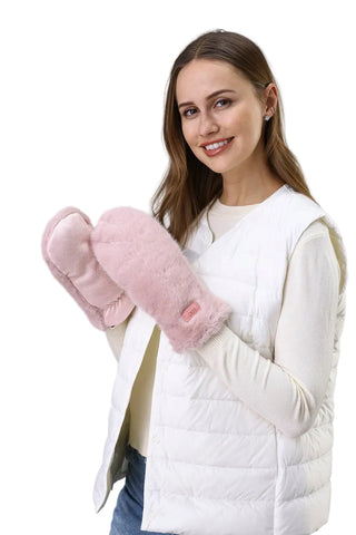 Woman wearing pink fuzzy mittens against a light background