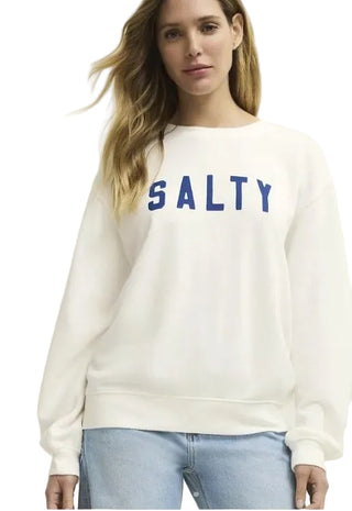 Woman wearing a white sweatshirt with 'SALTY' printed in blue on a plain background