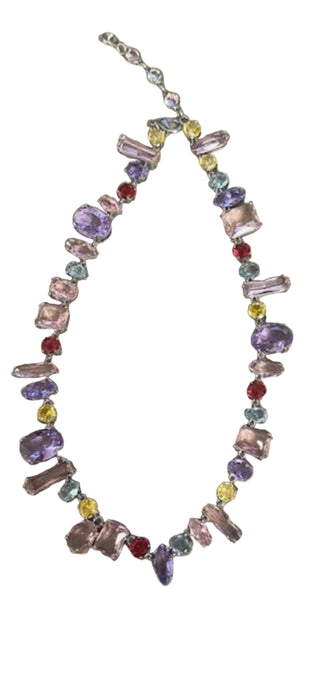 Multicolored gemstone necklace on a cardboard surface