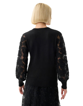 Black dress with sheer sleeves on a white background