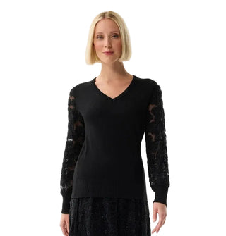 Woman wearing a black sweater with lace sleeves on a white background