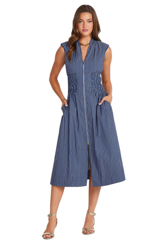 Woman wearing a blue striped dress on a white background