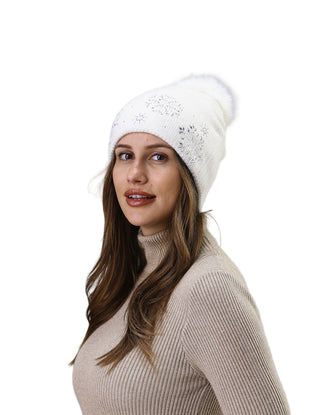 Woman wearing a white knit beanie and beige turtleneck sweater against a light gray background