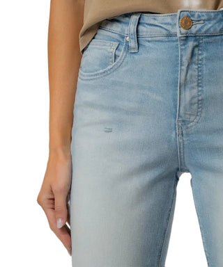 Light blue jeans worn by a person on a plain background