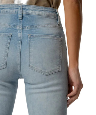 Light blue jeans worn by a person on a neutral background
