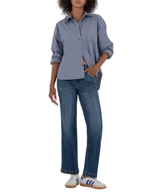 Person wearing a blue striped shirt and jeans on a beige background