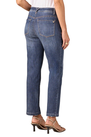 Blue jeans worn by a person on a neutral background