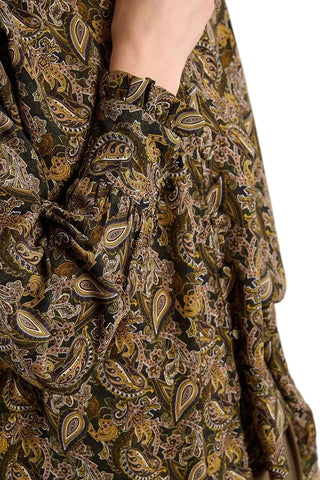 Close-up of a patterned fabric with intricate designs on a neutral background