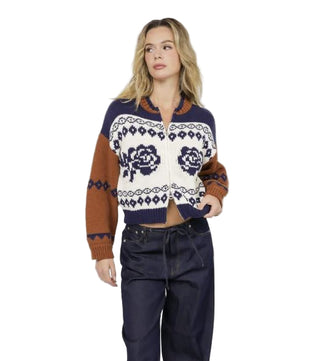 Woman wearing a patterned cardigan with a white background