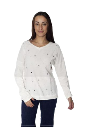 Woman wearing a white blouse with decorative buttons on a white background, featuring the brand 'Amorosa'.