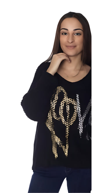 Woman wearing a black sweater with gold chain design on a white background