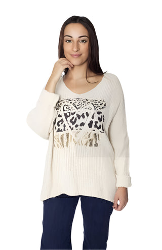 Woman wearing a beige sweater with leopard print accents on a white background