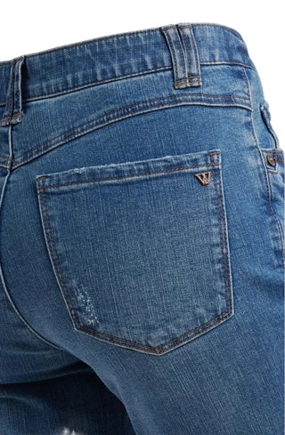 Close-up of blue jeans with a brand logo on the pocket.