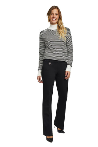 Woman wearing a striped sweater and black pants on a gray background