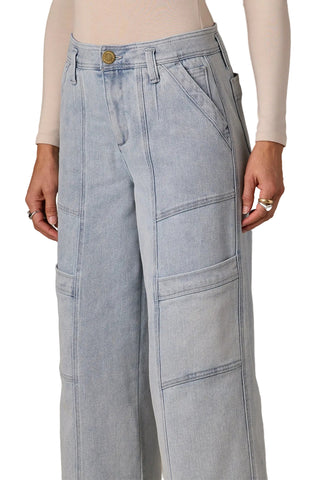 Light blue jeans worn by a person on a neutral background