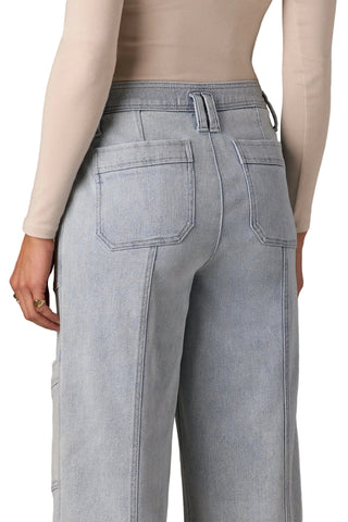 Light gray jeans worn by a person on a neutral background