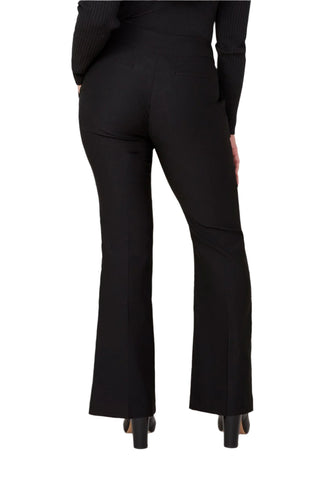 Black flared pants worn by a person on a white background