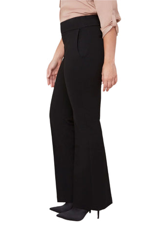 Person wearing black wide-leg pants on a white background