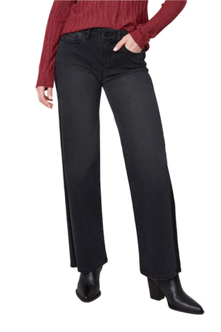 Person wearing black jeans and a red top on a white background