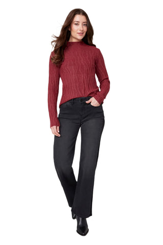 Woman wearing a red sweater and black pants on a white background