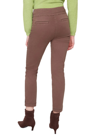 Person wearing brown pants and green sweater on a white background