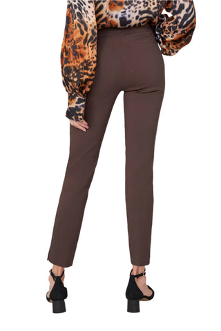 Brown pants worn with a leopard print top on a white background