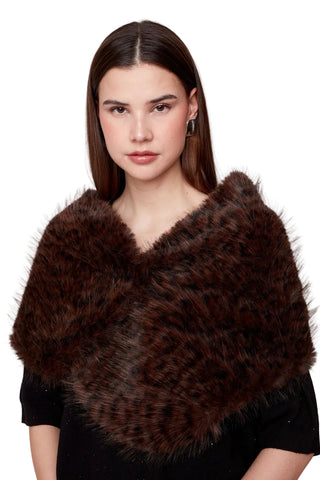 Woman wearing a brown fur shawl against a white background