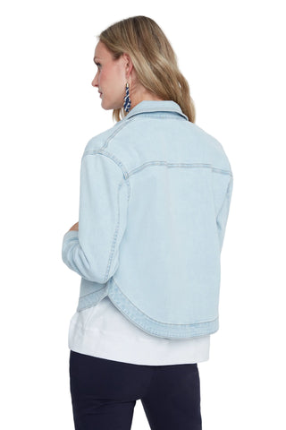 Woman wearing a light blue denim jacket on a white background