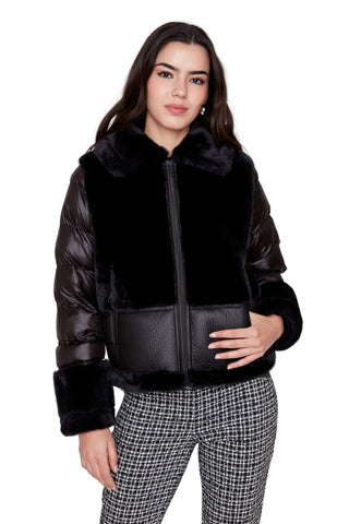 Woman wearing a black puffer jacket with fur trim on a white background