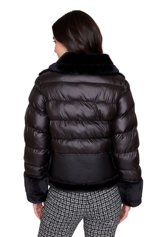 Person wearing a black puffer jacket on a white background