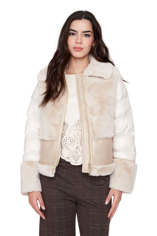 Woman wearing a cream fur-lined jacket on a white background