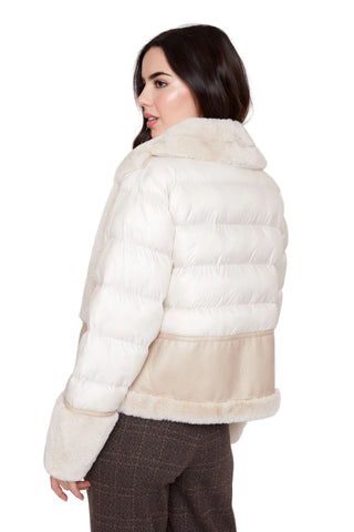 Woman wearing a white puffer jacket with fur trim on a white background