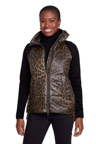 Woman wearing a leopard print vest over a black long-sleeve shirt on a white background