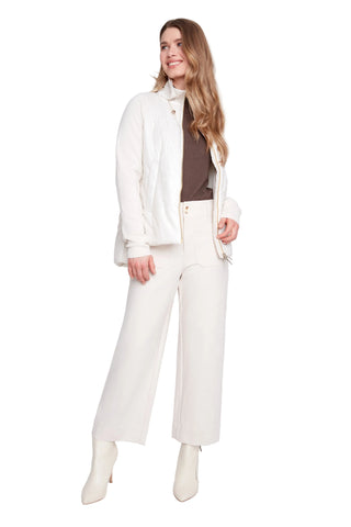 Woman wearing a white outfit with a brown top on a white background