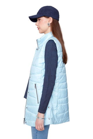 Person wearing a light blue puffer vest over a dark long-sleeve shirt on a plain background