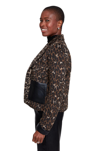 Person wearing a leopard print jacket on a white background