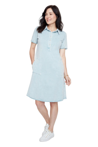Woman wearing a light blue dress with a white background