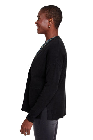 Person wearing a black sweater on a white background