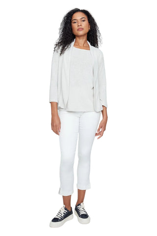 A woman modeling a light gray three-piece outfit consisting of a draped cardigan, a matching top, and white cropped pants, paired with black and white sneakers, against a plain light gray background.