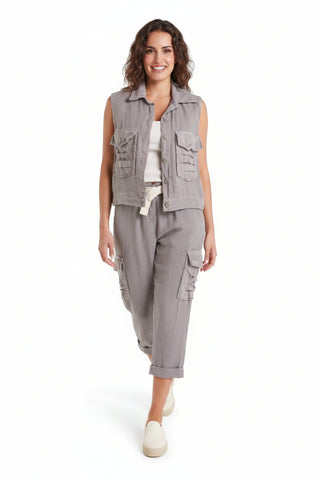 Woman wearing a sleeveless vest and cargo pants on a white background