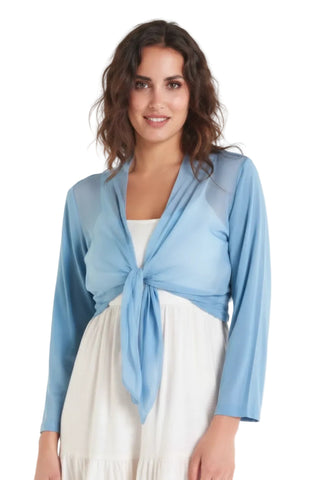 Woman wearing a light blue cardigan over a white dress on a white background