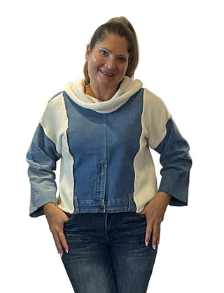 Woman wearing a blue and beige jacket with a white background