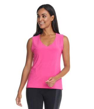 Woman wearing a pink sleeveless top and black leggings on a white background
