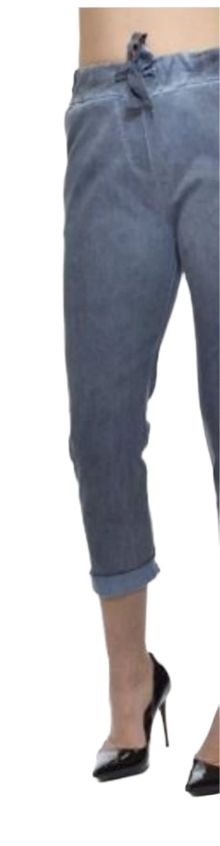 Blue jeans worn by a person on a white background
