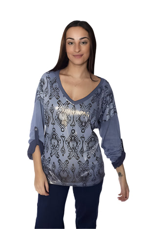 Woman wearing a blue patterned top with 'AMOROS' branding on a white background