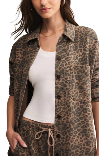 Person wearing a leopard print jacket over a white top
