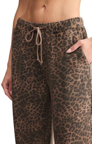 Leopard print pants with a drawstring waist on a neutral background