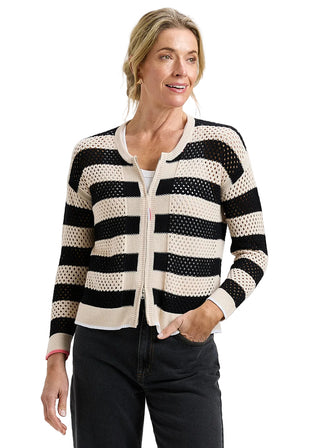 Woman wearing a black and white striped sweater on a plain background