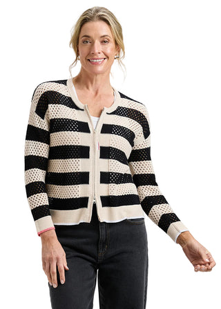 Woman wearing a black and white striped sweater on a gray background